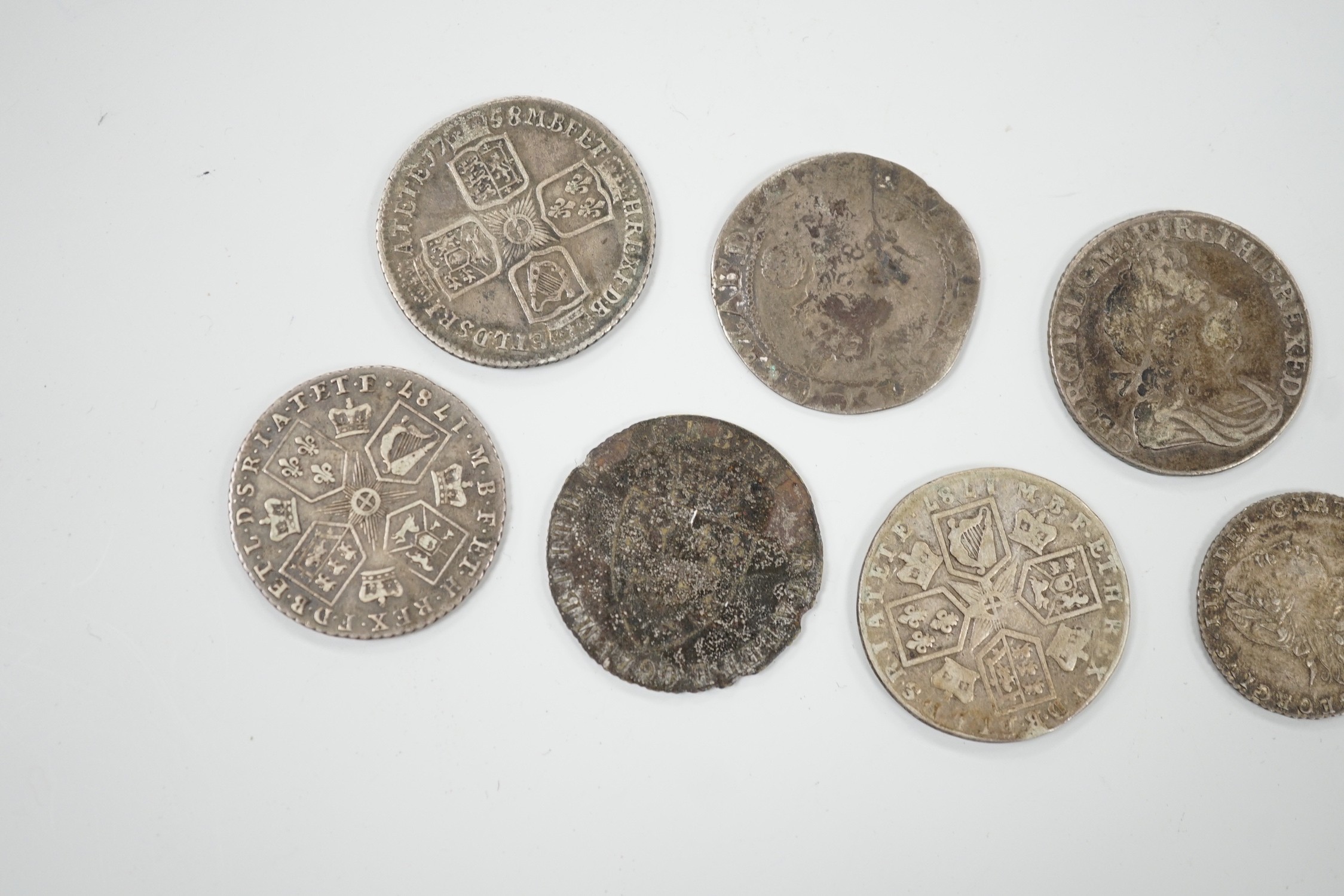 Four 18th century shillings, a sixpence an Elizabeth I coin and a token